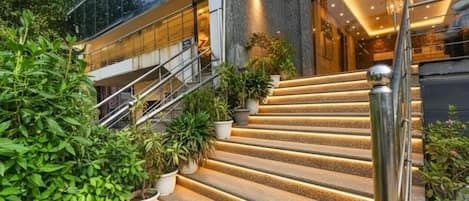 A set of outdoor stairs with a modern design, leading to a building entrance.