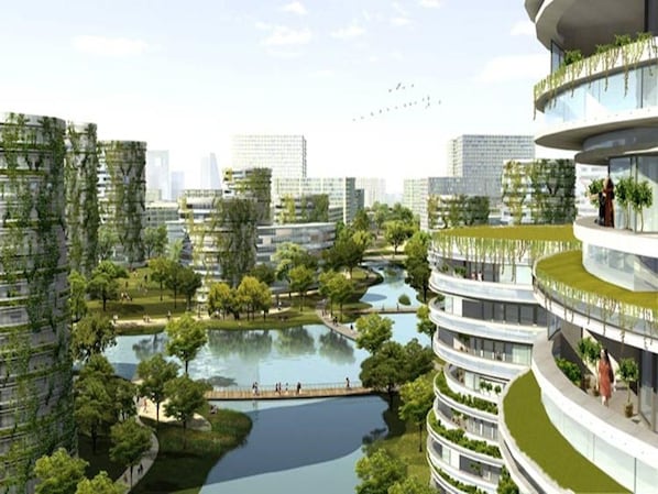 A modern urban residential area with high-rise buildings, green spaces, and a water body. - Vienna 3 Best Hotel (Tianjin)