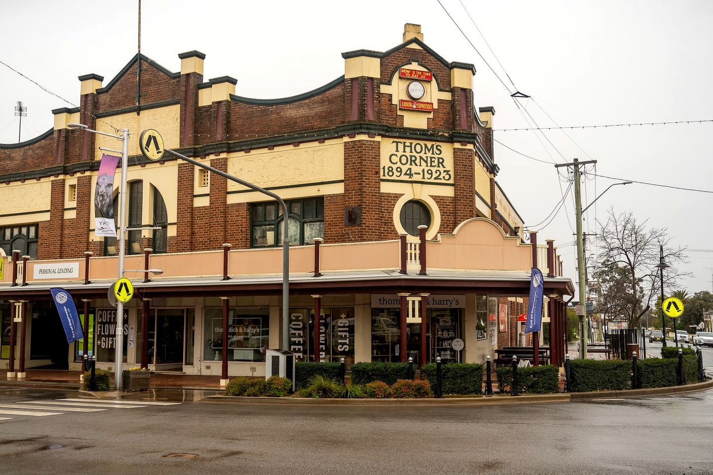 A historic building with a sign reading 'Thoms Corner 1894-1923'.