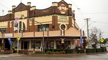 A historic building with a sign reading 'Thoms Corner 1894-1923'.
