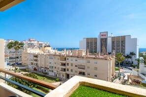 A coastal cityscape with a prominent building labeled 'RIU' featuring a modern design with balconies and a flat roof. - Apartment in Nerja Near Beaches & Pool (Nerja)