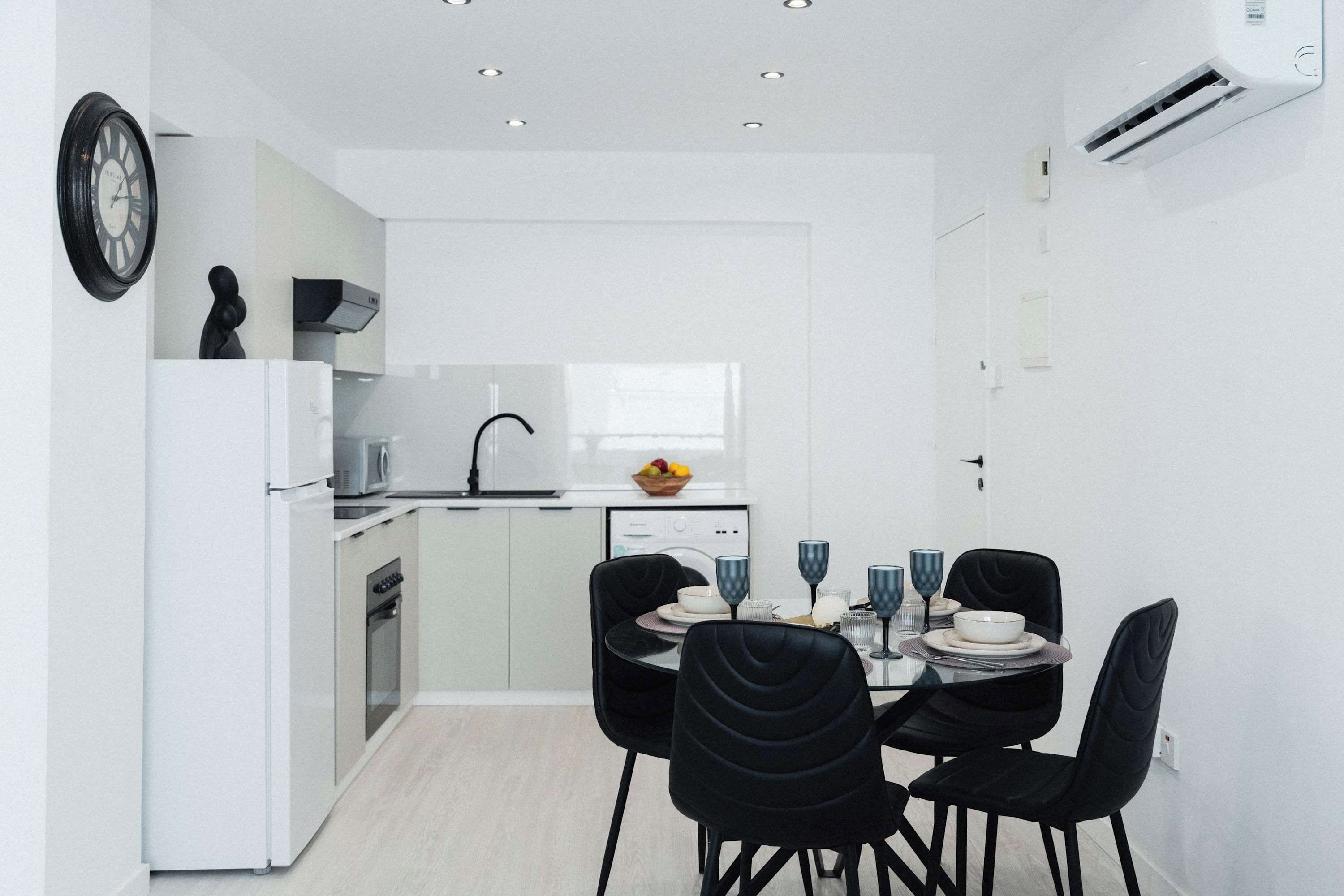 A modern kitchen with a dining area.