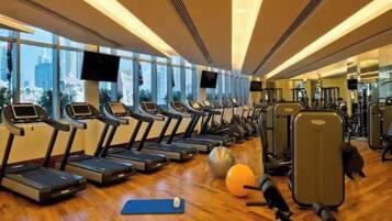 A gym with treadmills, exercise balls, and weights.