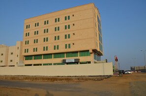 A multi-story hotel with a flat facade and numerous windows. - Golden New Armada (Jizan)