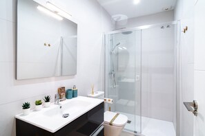 A modern bathroom with a glass shower enclosure, a white sink, and a large mirror. - Holiday Home With sea View, Nerja (Nerja)