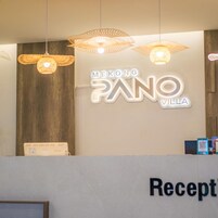 A reception desk with a sign that reads 'MEKONG PANO VILLA' and the word 'Reception' below it.