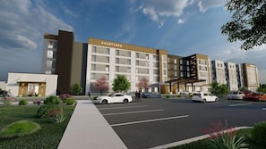 A multi-story hotel with a modern design, featuring a courtyard and a covered parking area. - Courtyard by Marriott Madison (Madison)
