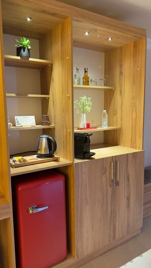 A compact kitchenette with a red refrigerator, wooden cabinets, and a countertop with a kettle and coffee machine. - CRASSULA URLA (Urla)