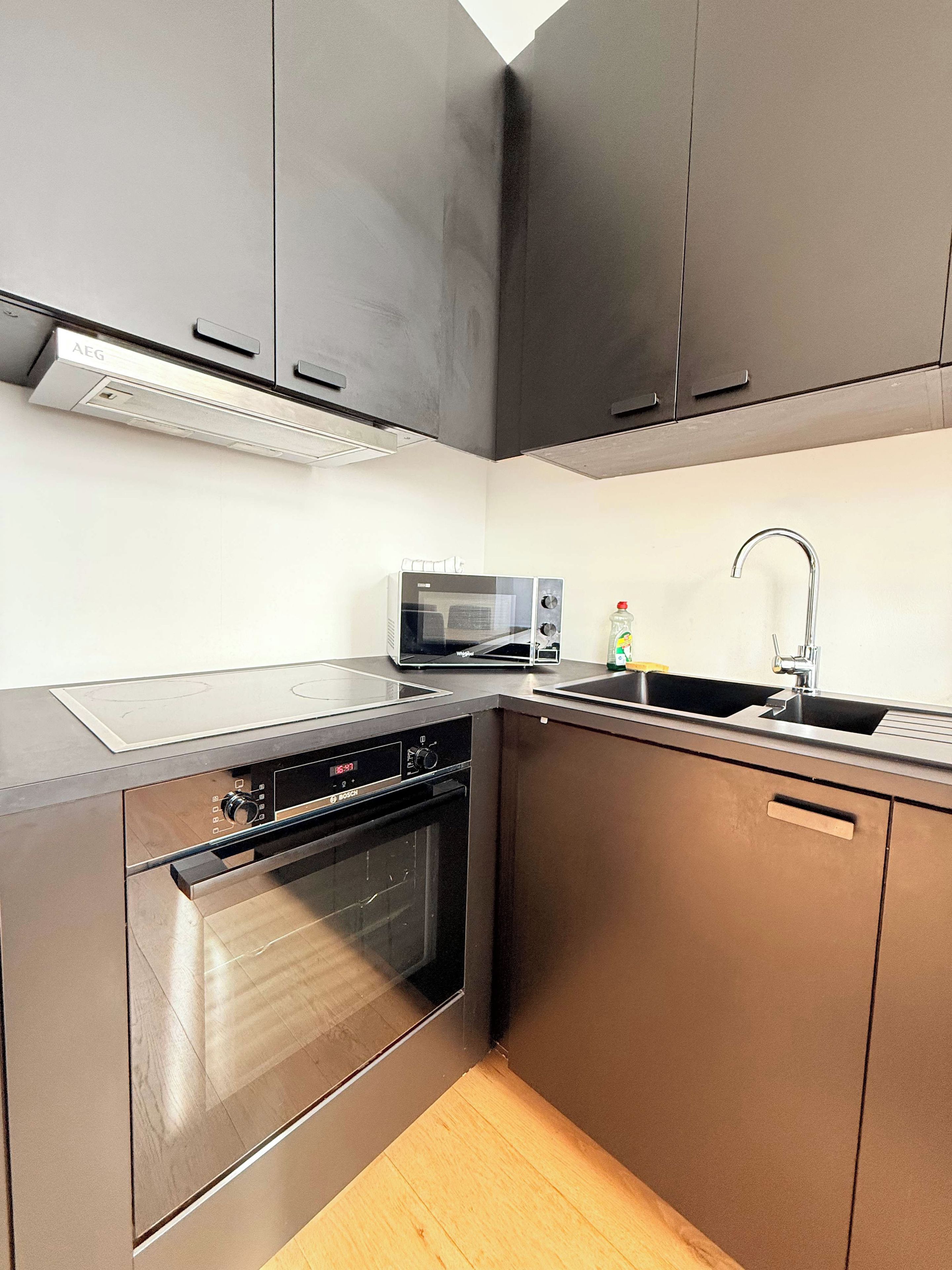A modern kitchen with stainless steel appliances, a microwave, and a built-in oven.