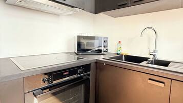 A modern kitchen with stainless steel appliances, a microwave, and a built-in oven.
