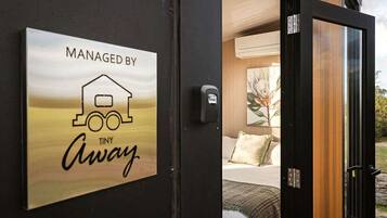 A door with a sign indicating the property is managed by Tiny Away.