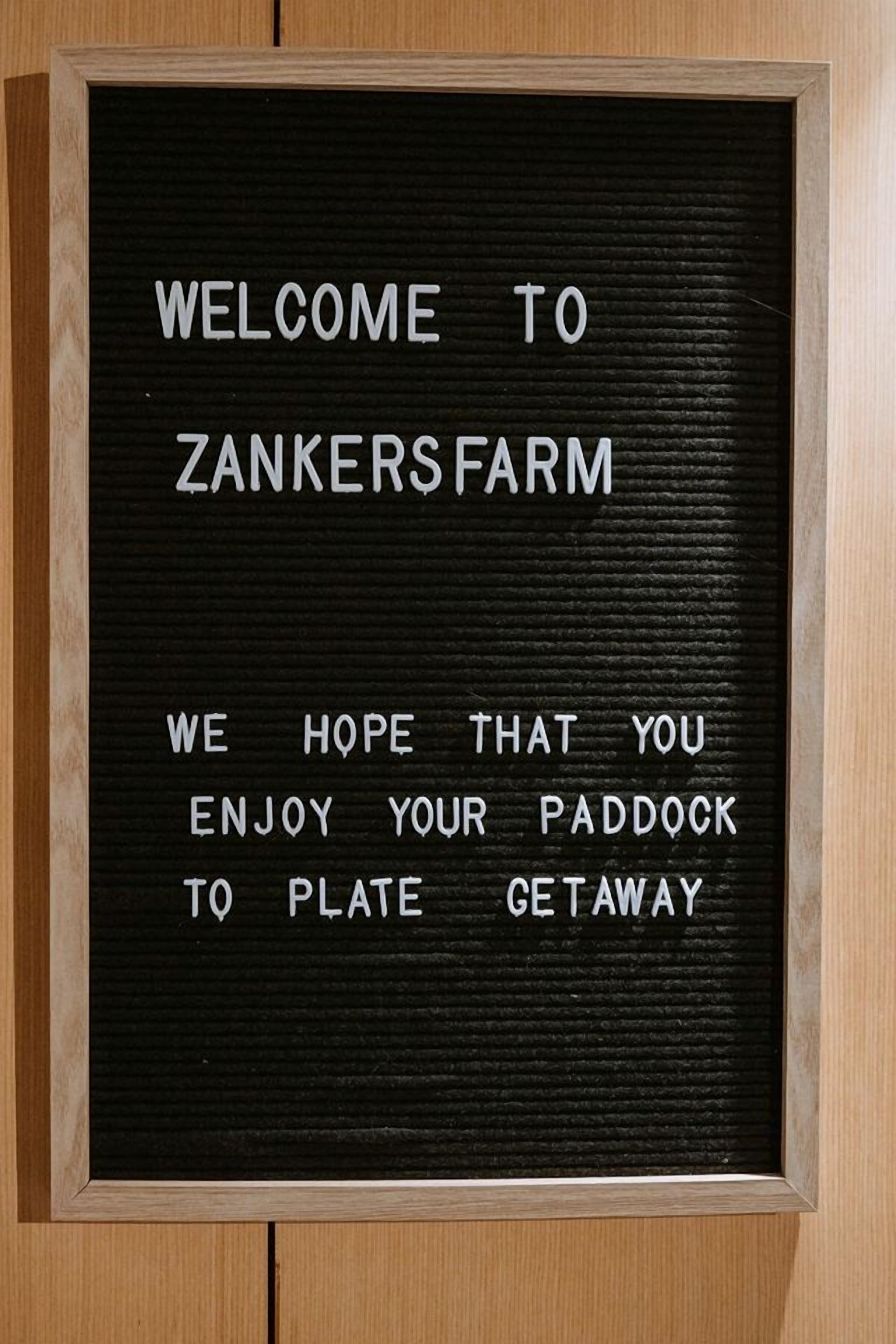 A framed welcome sign with text for Zankers Farm.