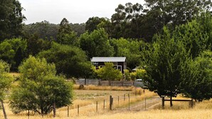 A rural landscape with a single building surrounded by trees and a fenced area. - The Perch in Korweinguboora, Victoria (Korweinguboora)