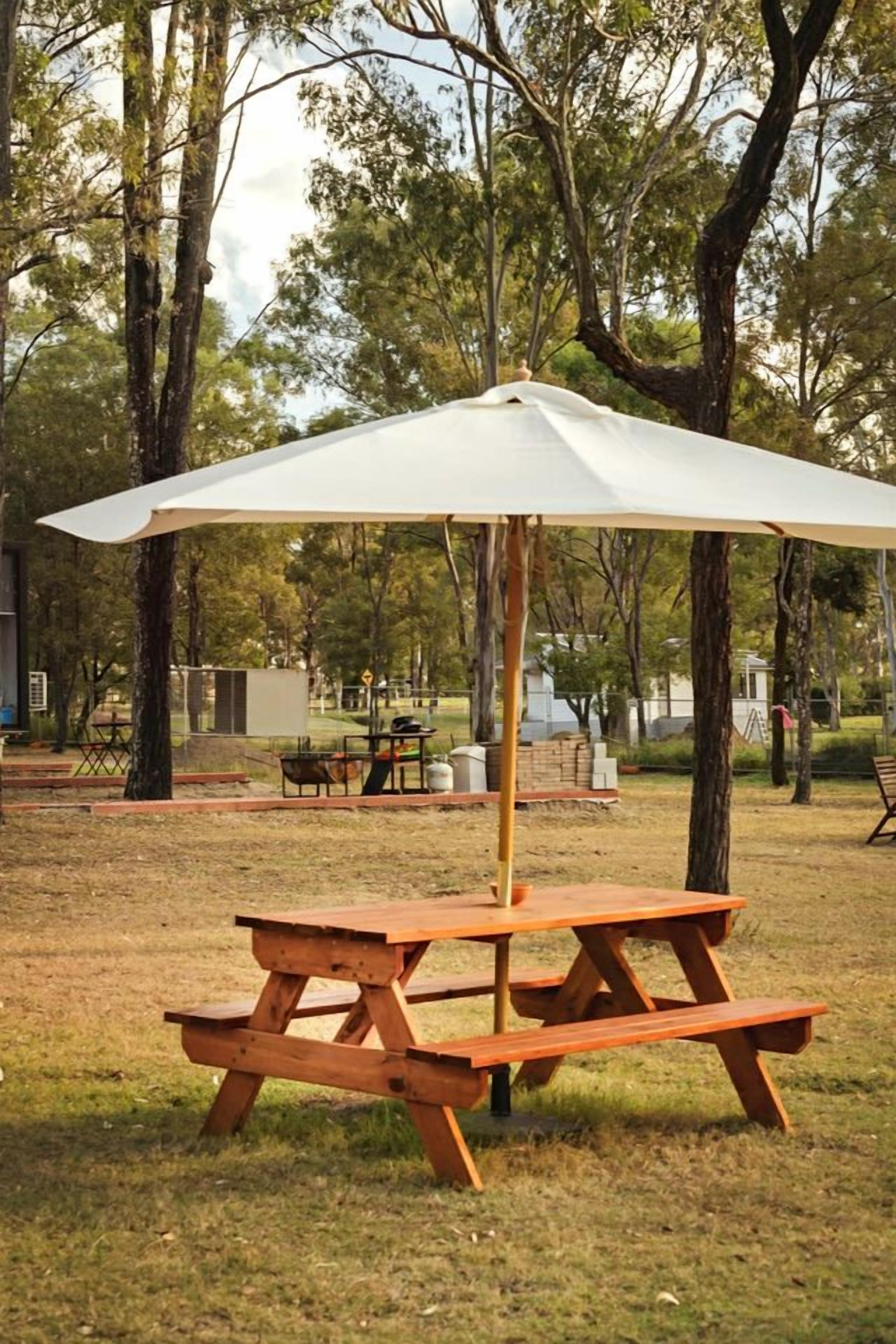 A picnic table with a canopy in a park setting.