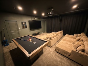 A room with a pool table, a large sofa set, and a flat-screen TV. - The Queen: 9 Bedroom/8Bath/7 En-suite Bedrooms/Sleeps 25+/LazyRiver/Pickleball (Coachella)