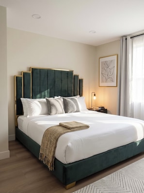 A modern hotel room with a large bed, a headboard with vertical panels, a bedside table with a lamp, and a framed artwork on the wall. - The Queen: 9 Bedroom/8Bath/7 En-suite Bedrooms/Sleeps 25+/LazyRiver/Pickleball (Coachella)