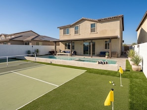 A two-story house with a swimming pool, tennis court, and a well-maintained lawn. - The Queen: 9 Bedroom/8Bath/7 En-suite Bedrooms/Sleeps 25+/LazyRiver/Pickleball (Coachella)