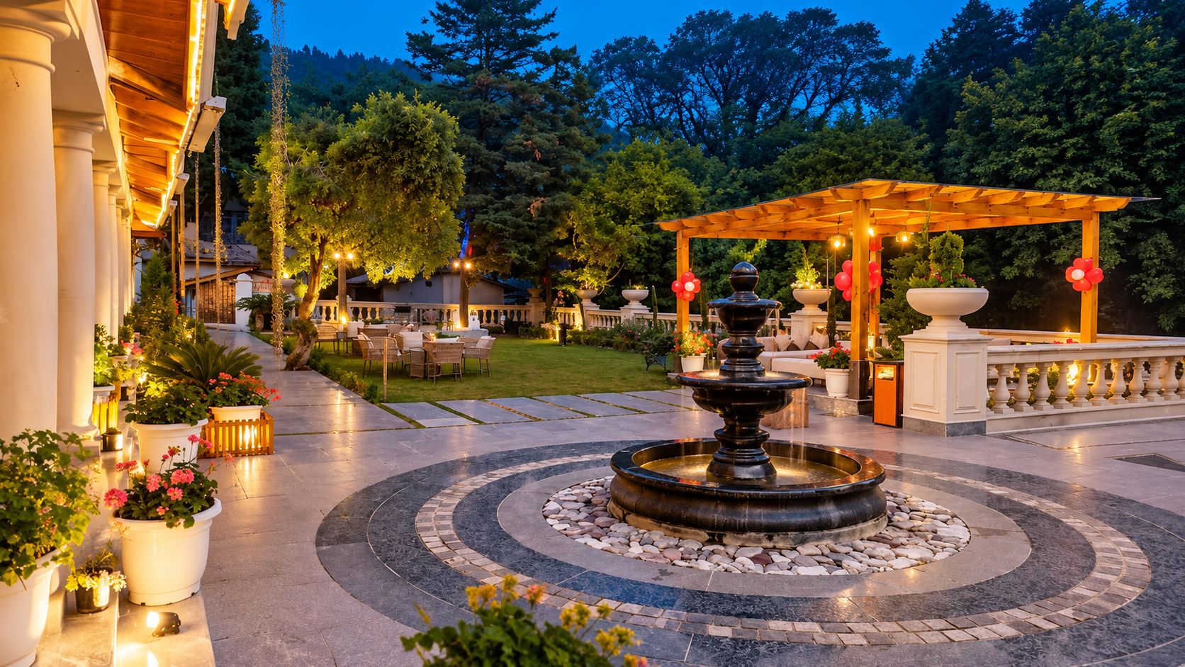 An outdoor patio area with a central fountain, seating arrangements, and a pergola with hanging lights.