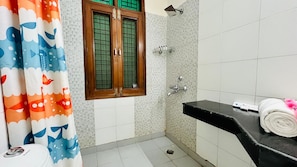 A bathroom with a shower, a toilet, and a sink. - Cotyard Banquet & Wedding Venue Delhi (New Delhi)