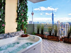 A hot tub with a cityscape view, including a tower and a skyscraper. - Penthouse Sky Jaccuzzi KLCC (Kuala Lumpur)