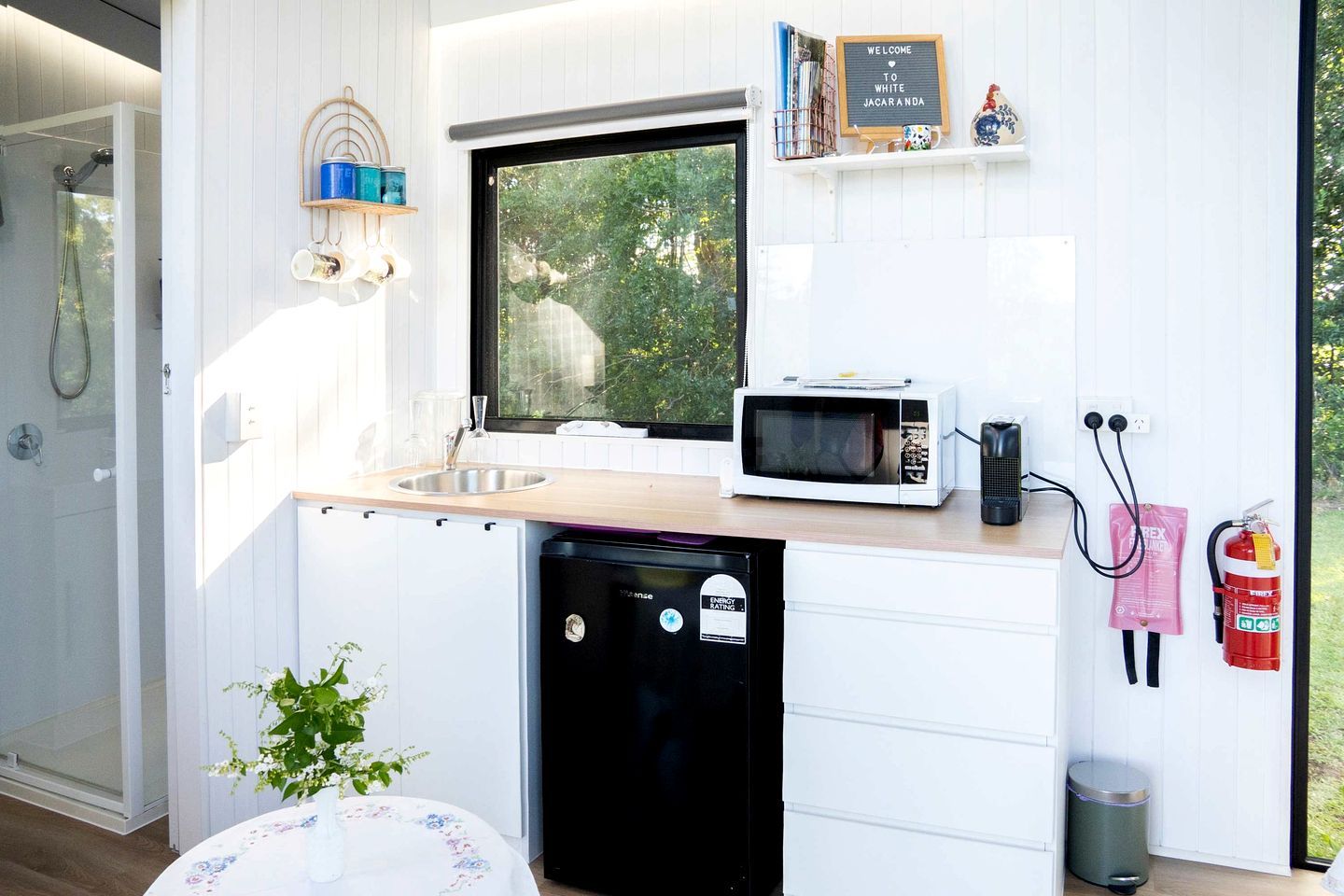 A compact kitchen with a built-in microwave, sink, and dishwasher.