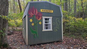 A small wooden structure with a window and a sign that reads 'ROSENDURFF' painted on the side. - The Rosendorff - Cabin CB4 (Parsons)