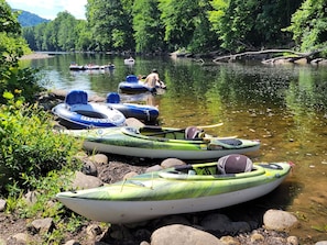 Kayaks and inflatable rafts docked at a riverbank. - The St. George - Cabin CB5 electric/heat (Parsons)