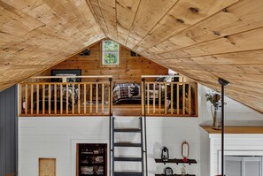 A loft-style bedroom with a wooden ceiling, a bunk bed, and a skylight. - Cozy 2 Bed 2 Bath River Cabin Hot Tub Ellijay GA Blue Ridge Mt Pet Friendly (Ellijay)