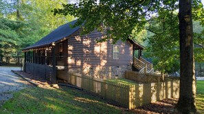 A log cabin with a porch and a staircase leading to a deck. - Cozy 2 Bed 2 Bath River Cabin Hot Tub Ellijay GA Blue Ridge Mt Pet Friendly (Ellijay)