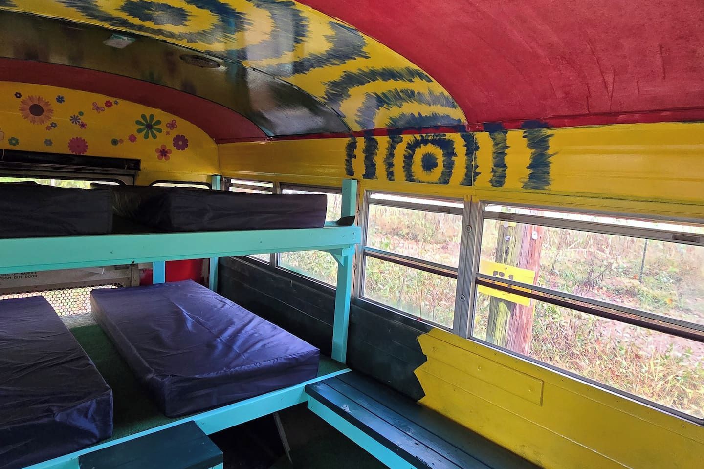 Une chambre avec un lit superposé et une fenêtre donnant sur l’extérieur.
