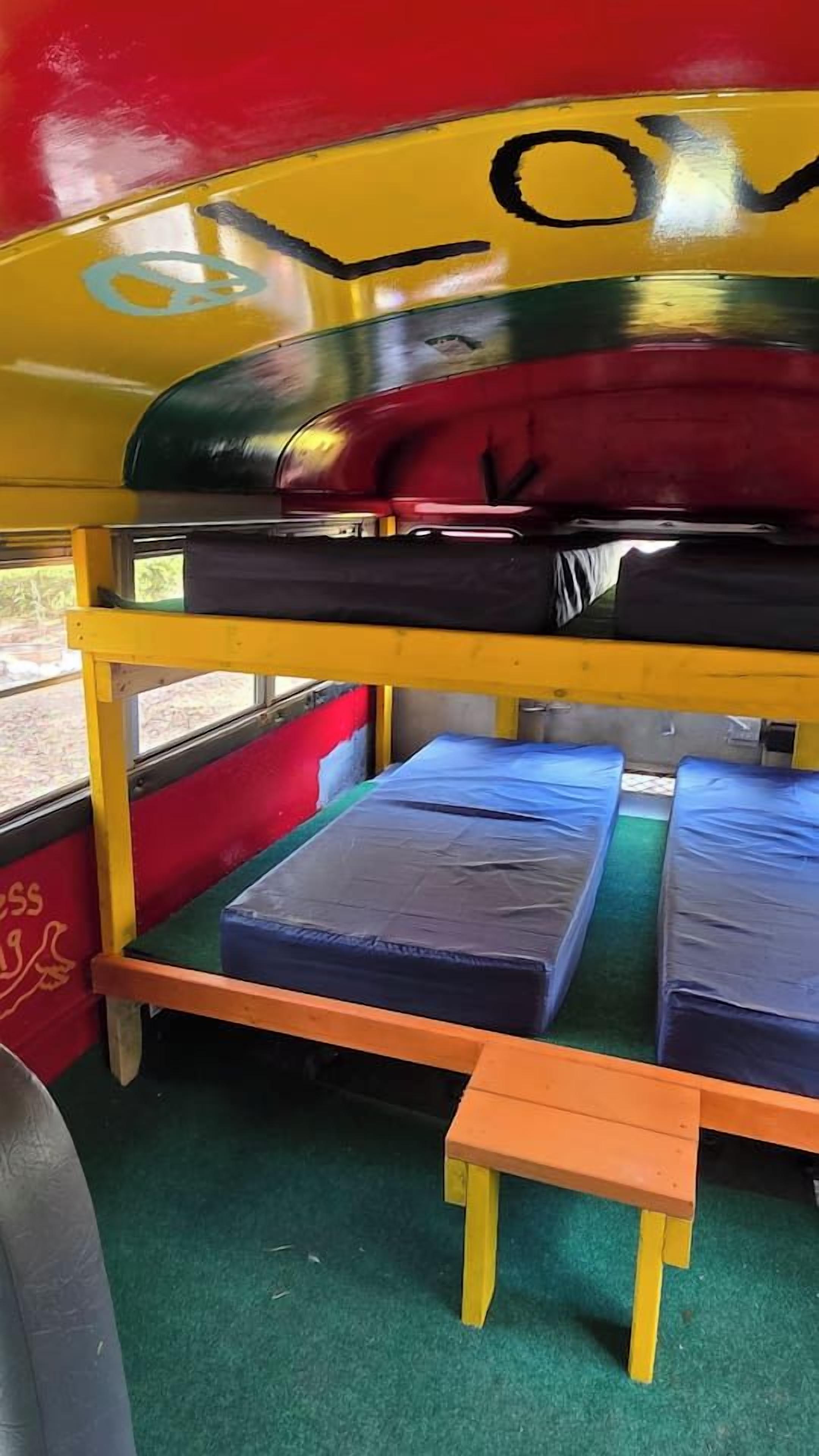 Un lit superposé avec un matelas en haut et un lit inférieur avec un oreiller.