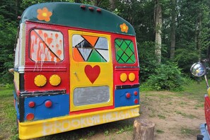 A colorful bus with a heart symbol and the text 'BROOKLYN HEIGHTS' on the side. - C1 Bohemian Bus Retreat | Two Vintage Buses (Parsons)