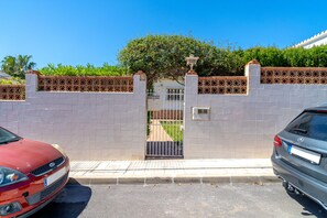 A gated driveway with a car parked on the side. - Villa in Nerja With Pool Near Burriana Beach (Nerja)