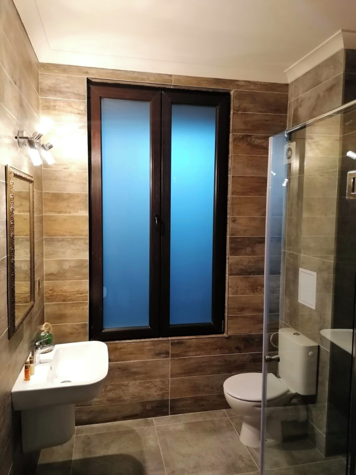 A bathroom with a toilet, sink, and shower.
