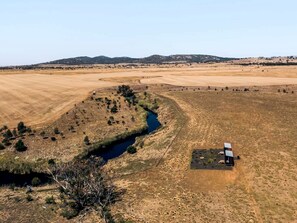 A rural landscape with a small building near a river. - Fantastic Secluded Tiny House in Wyndham Vale, Victoria (Wyndham Vale)