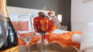 A bottle of Cantina Prosecco, a glass, and a bouquet of flowers on a tray.