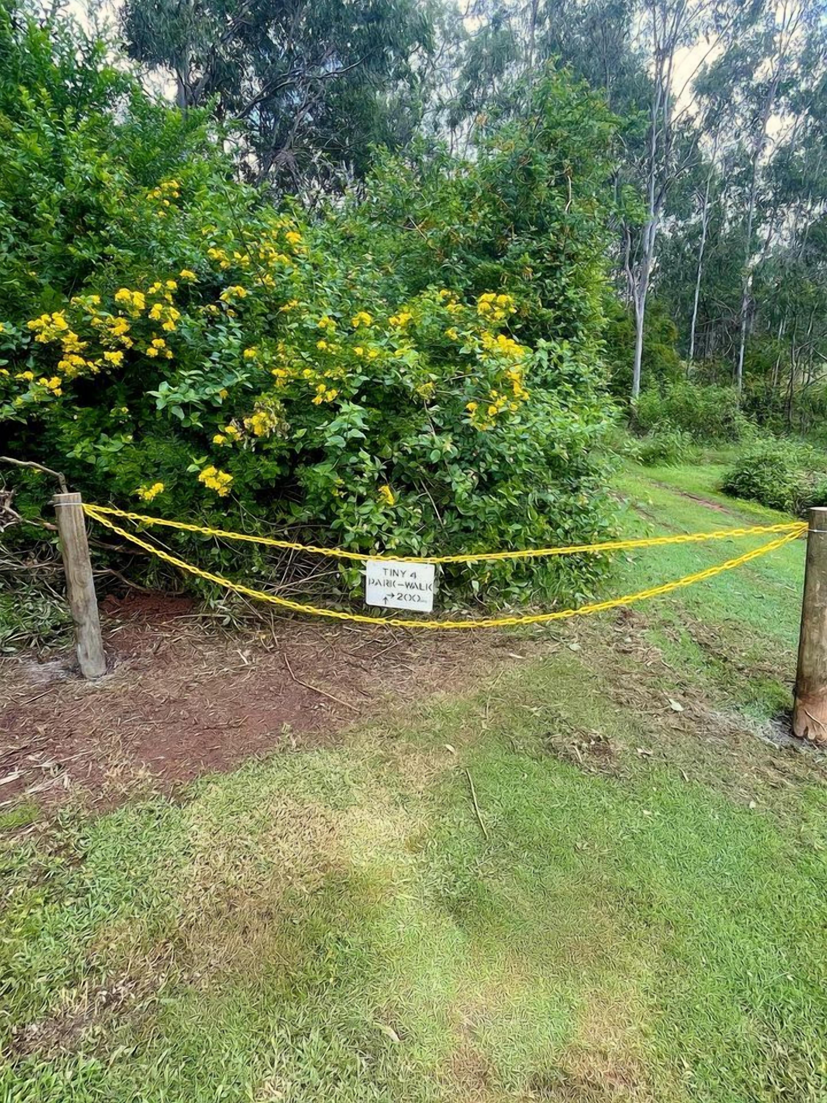 A fenced area with a sign indicating a 200-meter walking path.