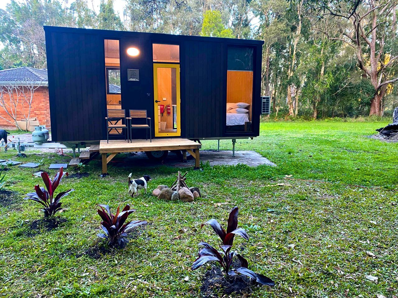 A modern, compact cabin with a visible sleeping area and a small deck.