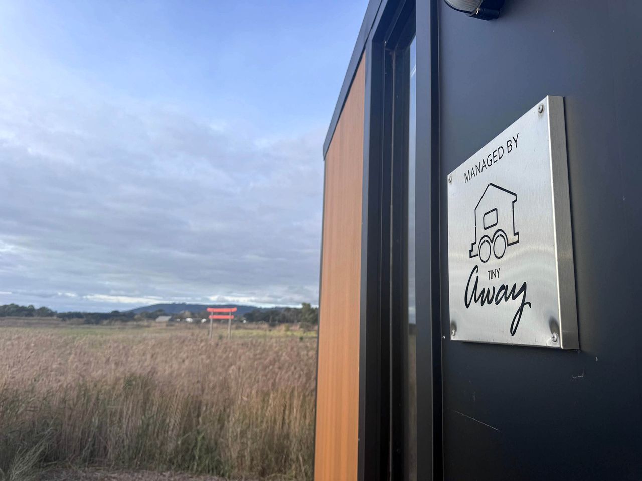 A door with a sign indicating management by Tiny Away.