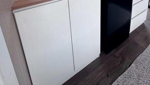 A modern kitchen with a built-in dishwasher, a window above the sink, and a small countertop. - Farm Stay Tiny House with Nature Escape Views in Boneo, Australia (Boneo)