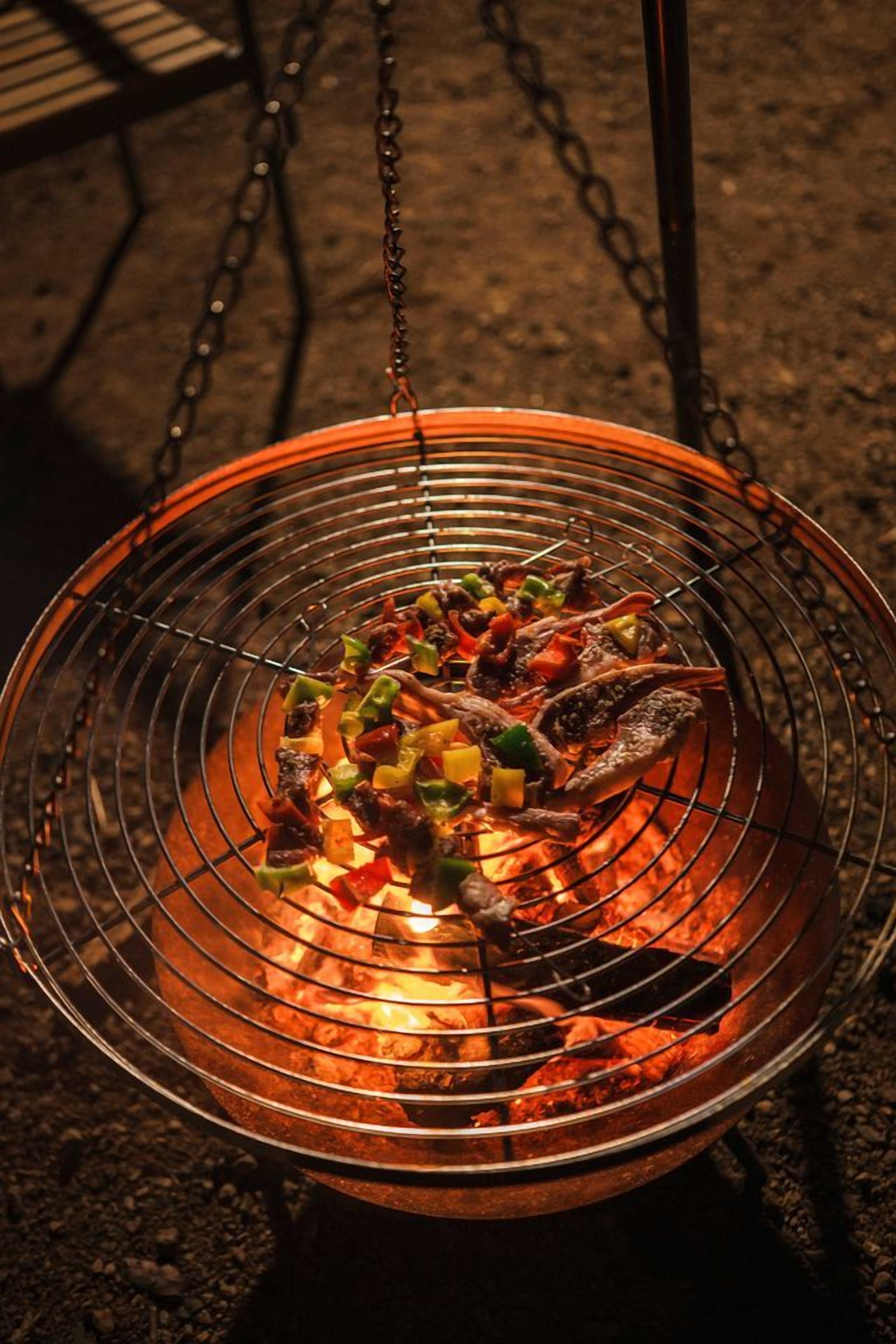 A grill with food being cooked over an open flame.