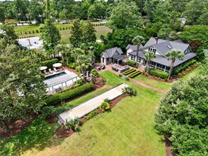 A large house with a swimming pool, patio, and well-maintained garden. - La Laval At Winyah Bay Main And Guest House 8 Bedroom Home (Georgetown)