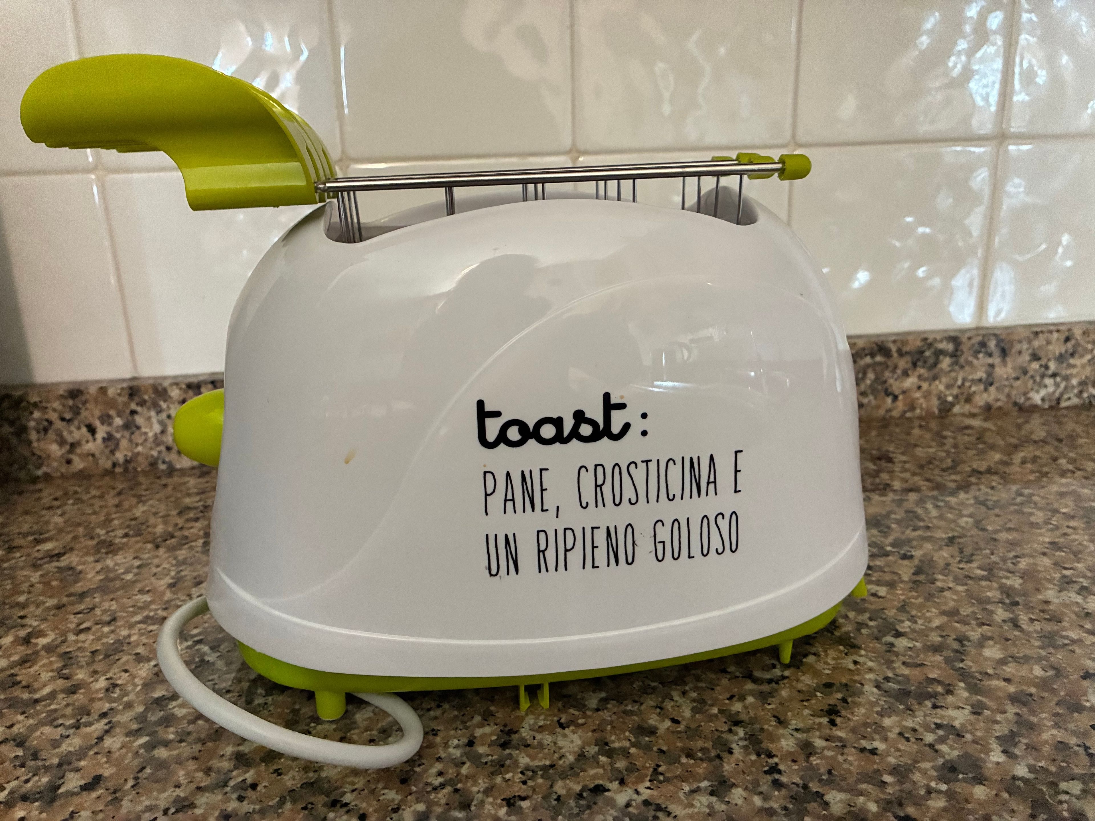 A kitchen appliance with a white and green color scheme, featuring a label with text.