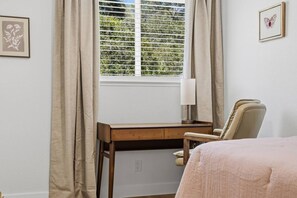 A bedroom with a bed, a desk, a chair, a window with blinds, and a lamp. - Stunning 4BR Estate | Secluded Folsom Getaway (Folsom)