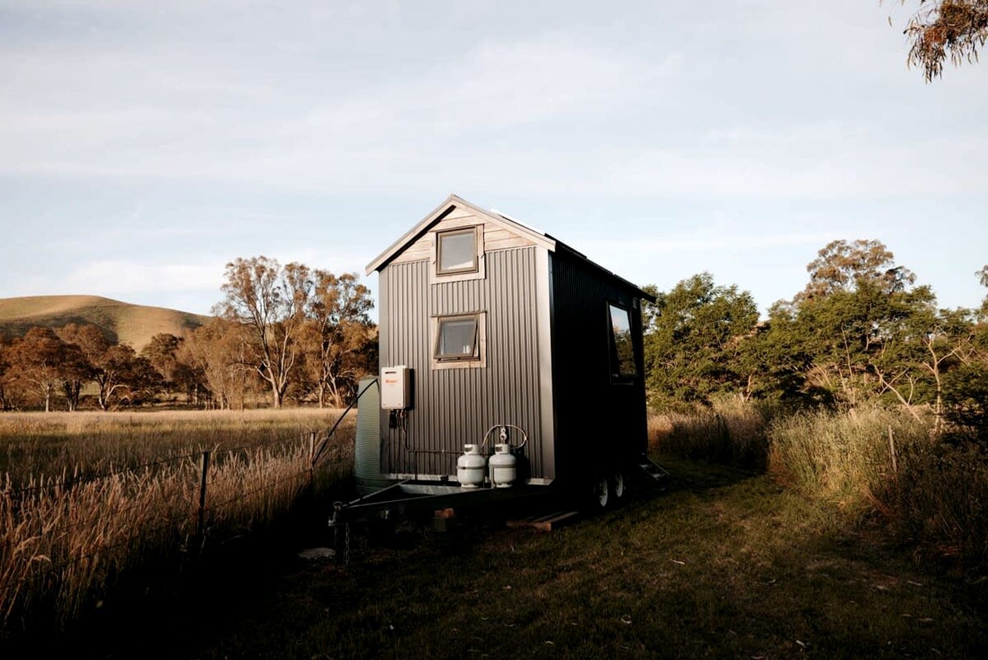 A small, single-story cabin with a gabled roof, a front door, and a small porch area.
