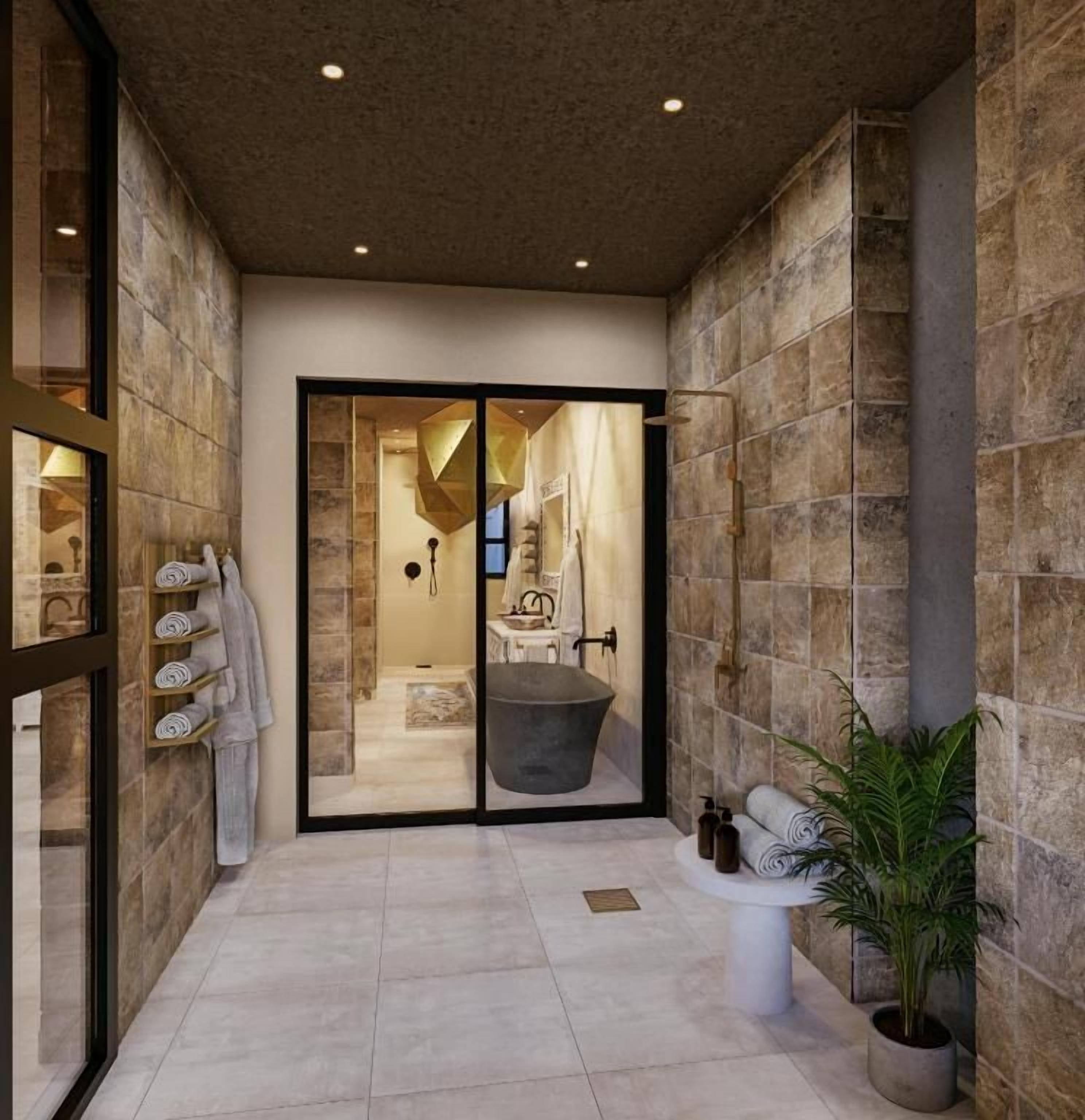 A modern bathroom with a bathtub, a sink, and a potted plant.