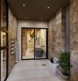 A modern bathroom with a bathtub, a sink, and a potted plant. - Shah Palace Zanzibar (Matemwe)