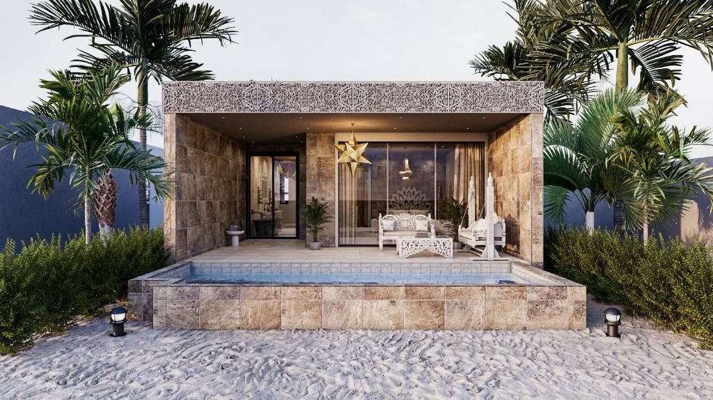 A modern building with a pool, outdoor seating, and palm trees.