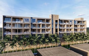 Hotel moderno com várias varandas, fachada de pedra e vista para a paisagem ao redor.