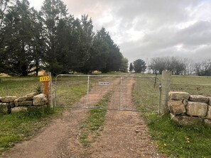 A gated entrance to Lexington Park with a dirt path leading through.